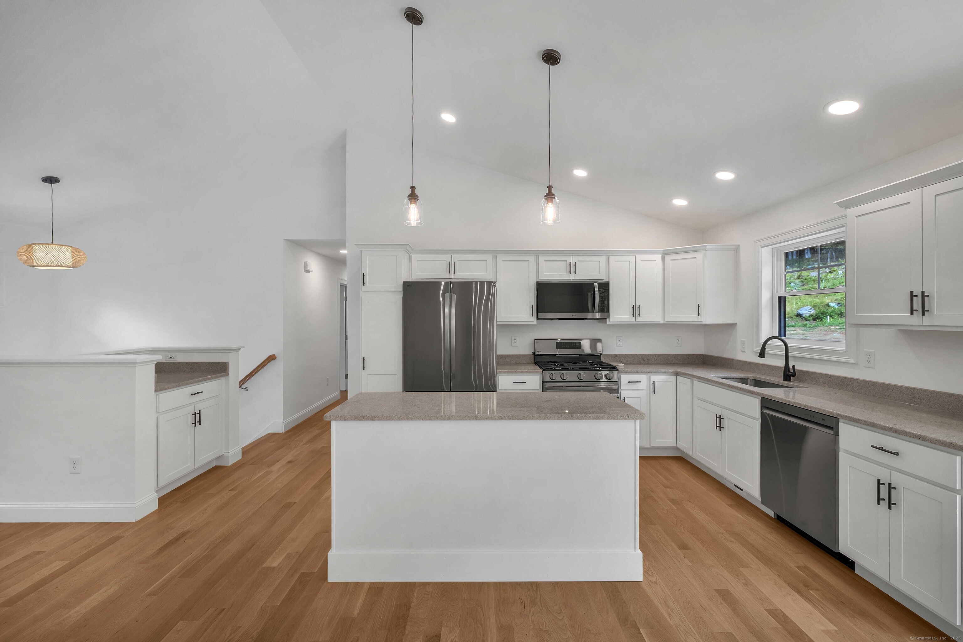 4 Lake Of Isles Road North Stonington, CT 06359 - Photo 10 of 23 a large kitchen with stainless steel appliances kitchen island a large counter top and a wooden floors