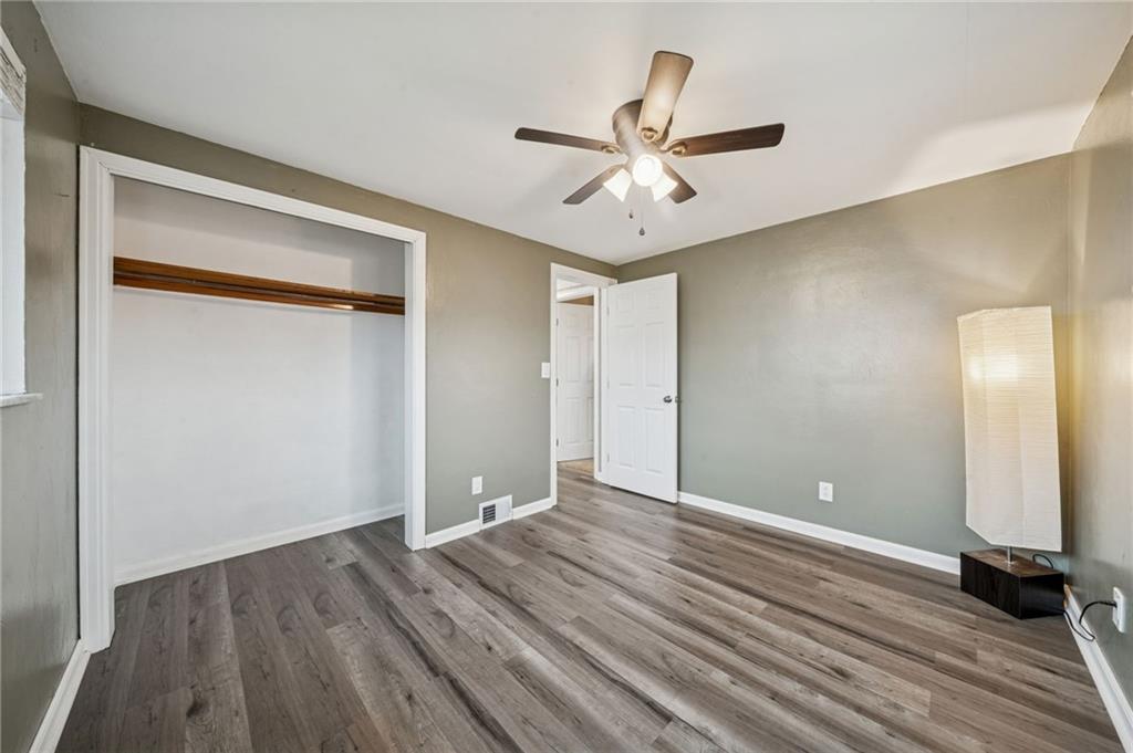 10660 Crestview Drive Irwin, PA 15642 - Photo 14 of 31 a view of a room with wooden floor and a ceiling fan
