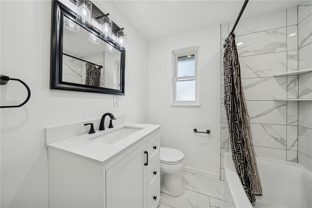 10660 Crestview Drive Irwin, PA 15642 - Photo 15 of 31 a bathroom with a sink a mirror and a toilet