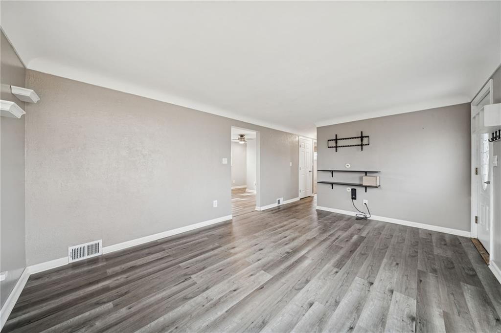 10660 Crestview Drive Irwin, PA 15642 - Photo 4 of 31 wooden floor in an empty room with a window