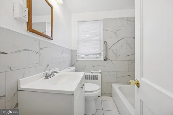 a bathroom with a sink a toilet and bathtub