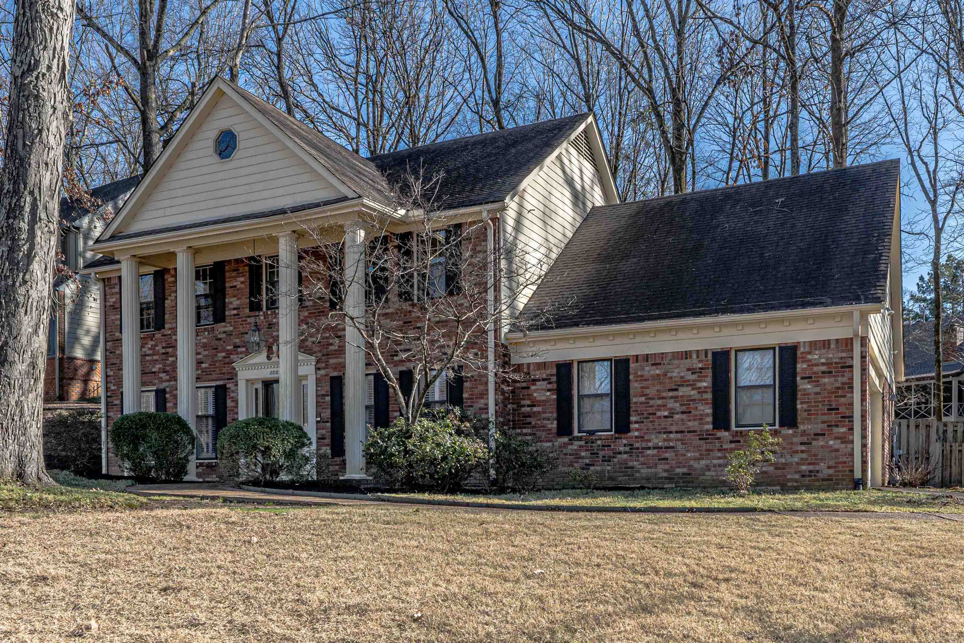 8883 Farmoor Road Germantown, TN 38139 - Photo 2 of 34 Neoclassical / greek revival house with brick siding, a porch, and roof with shingles