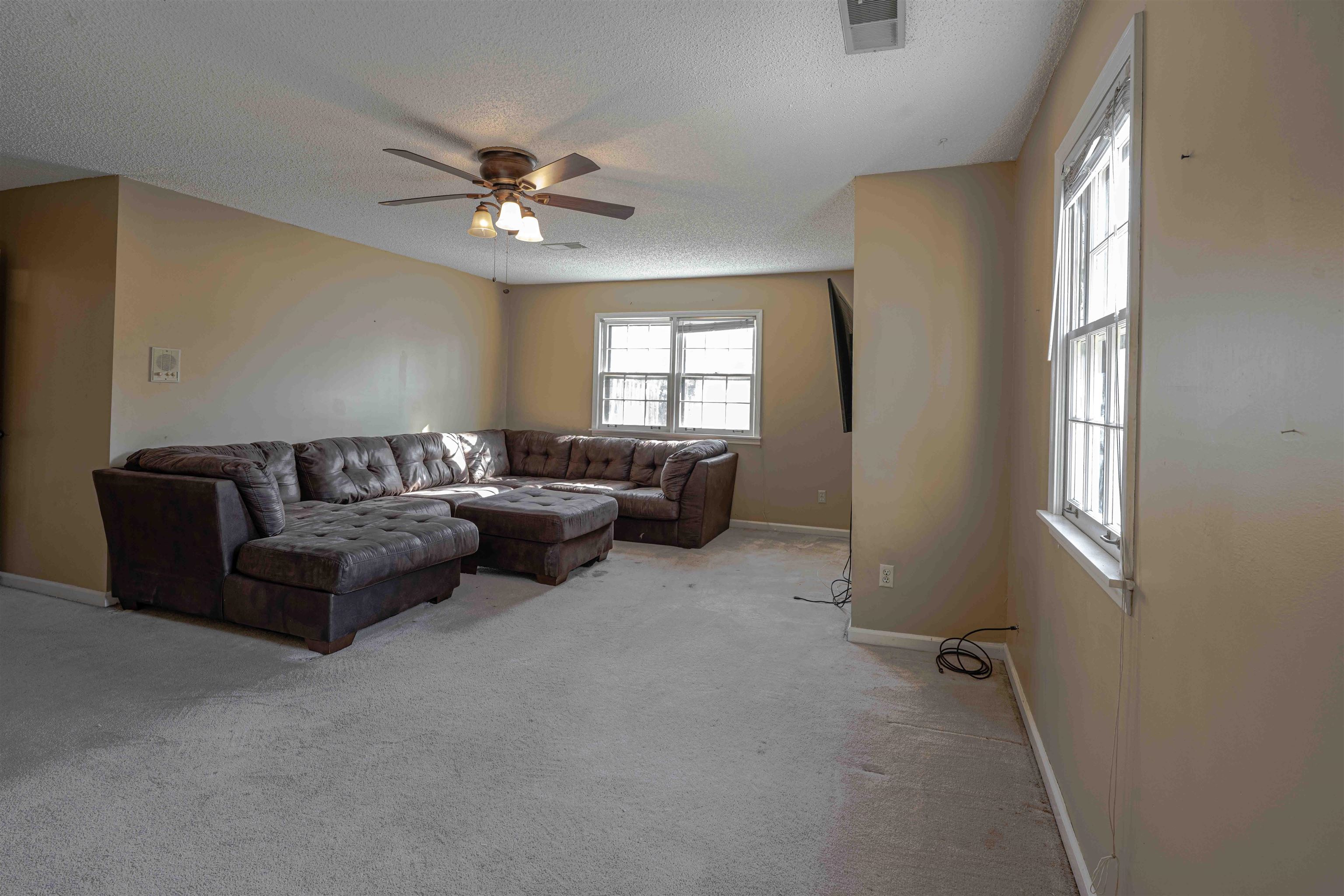 8883 Farmoor Road Germantown, TN 38139 - Photo 28 of 34 Carpeted living room featuring a textured ceiling and ceiling fan