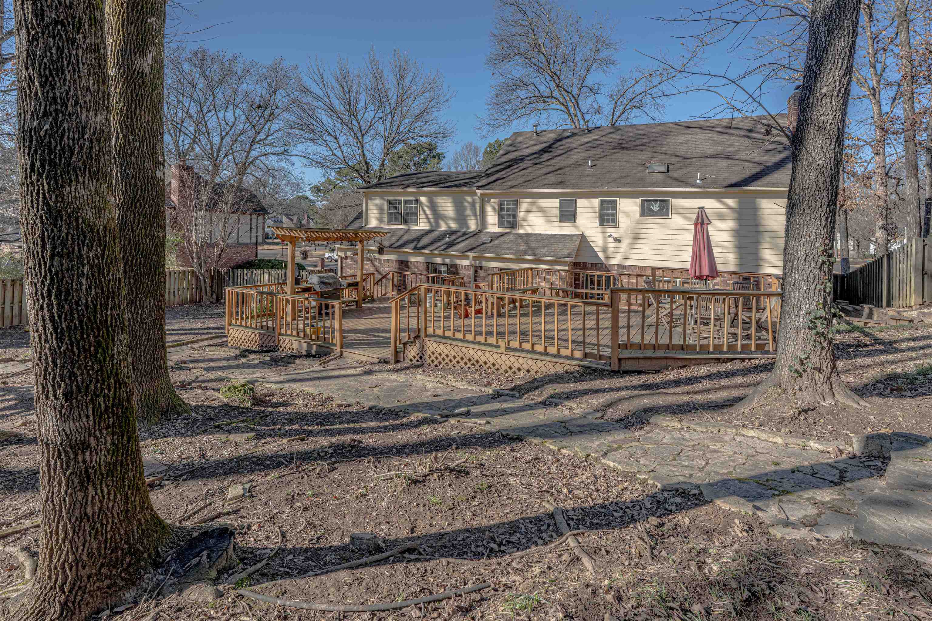 8883 Farmoor Road Germantown, TN 38139 - Photo 32 of 34 View of front facade with a fenced backyard, a deck, and roof with shingles
