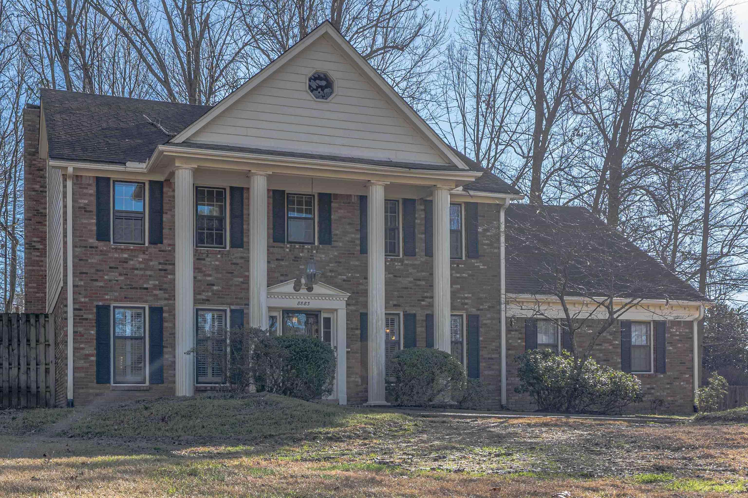 8883 Farmoor Road Germantown, TN 38139 - Photo 4 of 34 Neoclassical home featuring brick siding and a porch