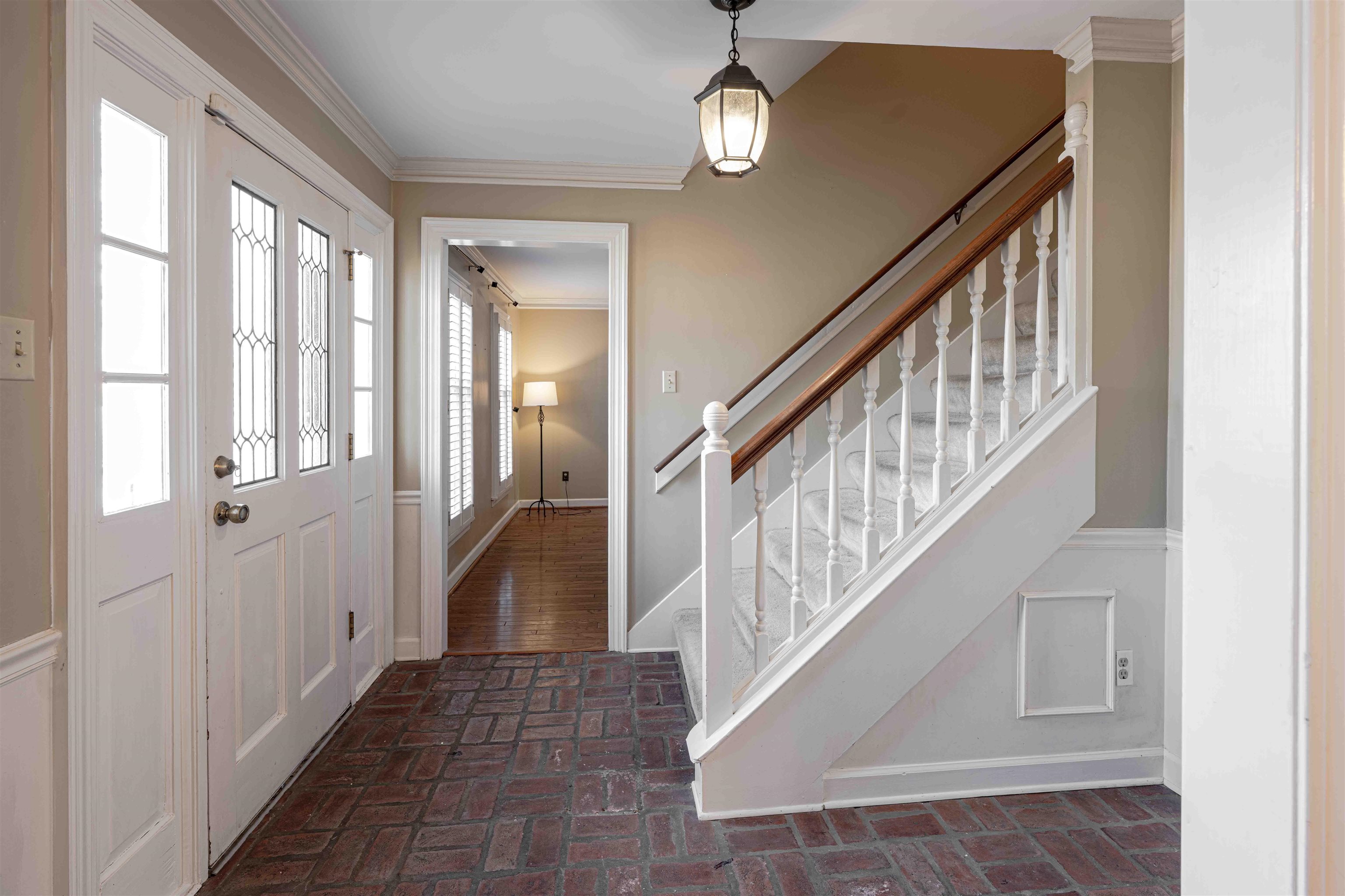 8883 Farmoor Road Germantown, TN 38139 - Photo 5 of 34 Foyer entrance featuring brick flooring, crown molding, and stairs