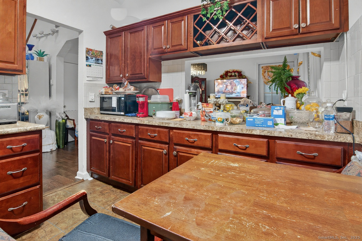 855 Oronoke Road, Unit 2 Waterbury, CT 06708 - Photo 4 of 12 a kitchen with stainless steel appliances granite countertop a sink and cabinets