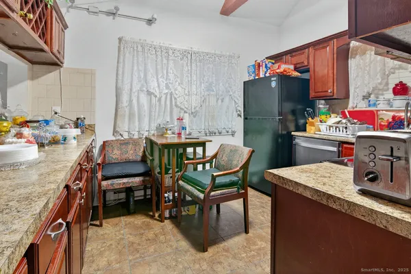 a kitchen with a dining table and chairs