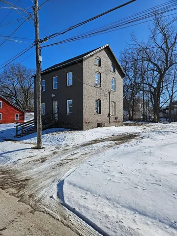 a front view of a building with a yard