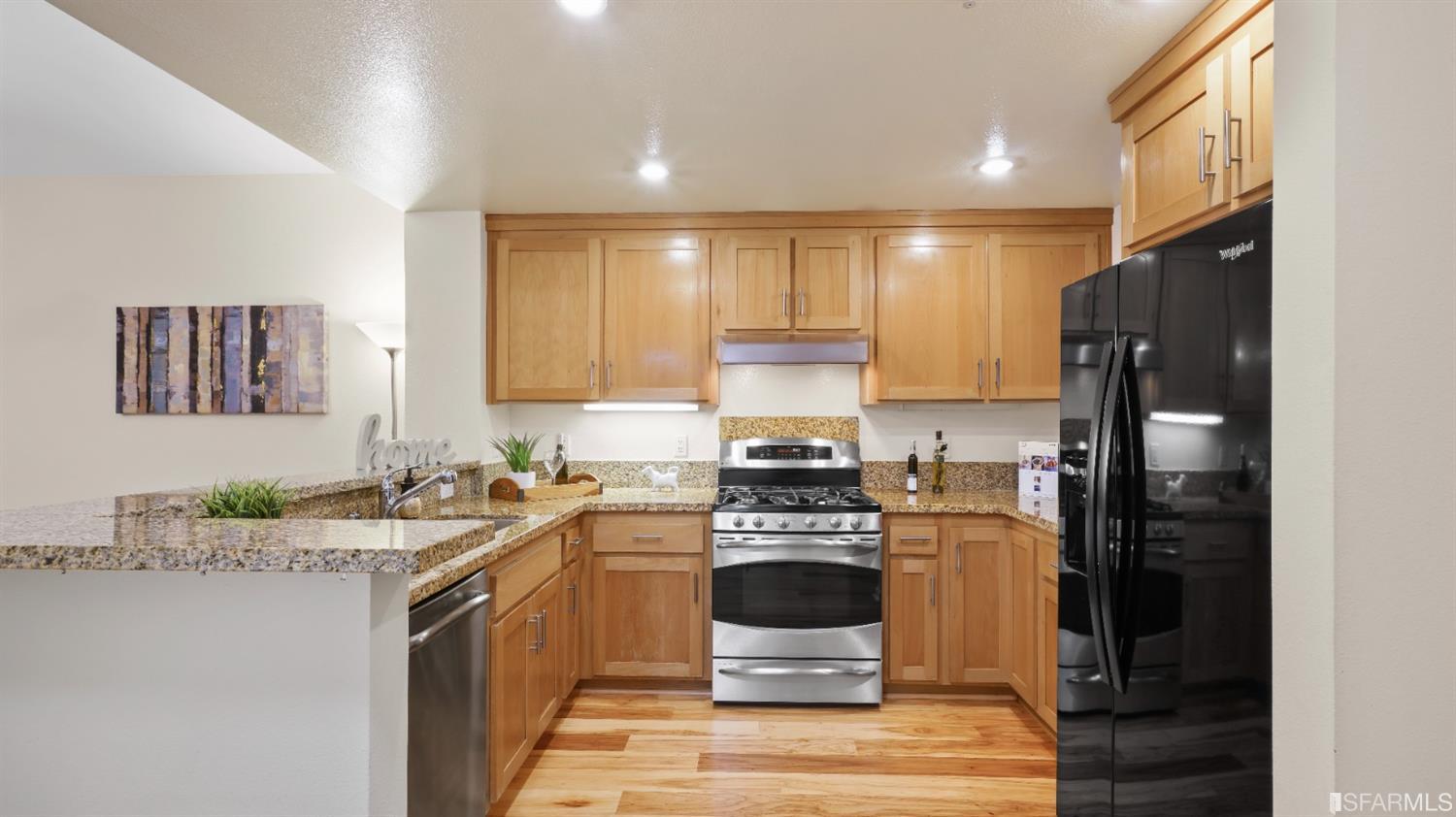 301 Crescent Court, Unit 3117 San Francisco, CA 94134 - Photo 2 of 34 a kitchen with a sink stove and refrigerator