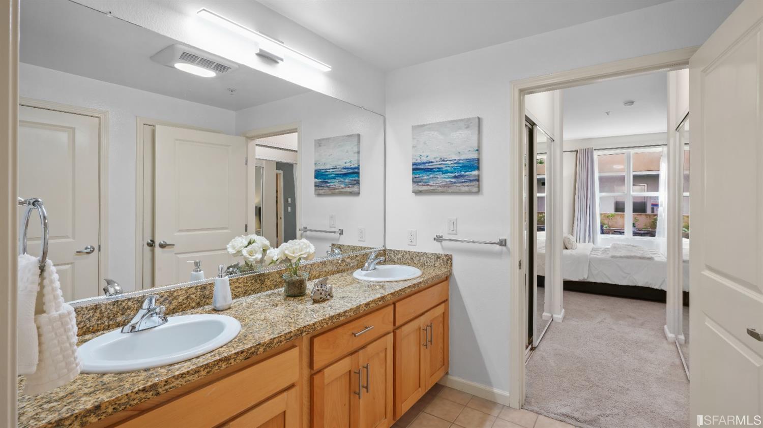 301 Crescent Court, Unit 3117 San Francisco, CA 94134 - Photo 11 of 34 a en suite bathroom with double vanity and a mirror