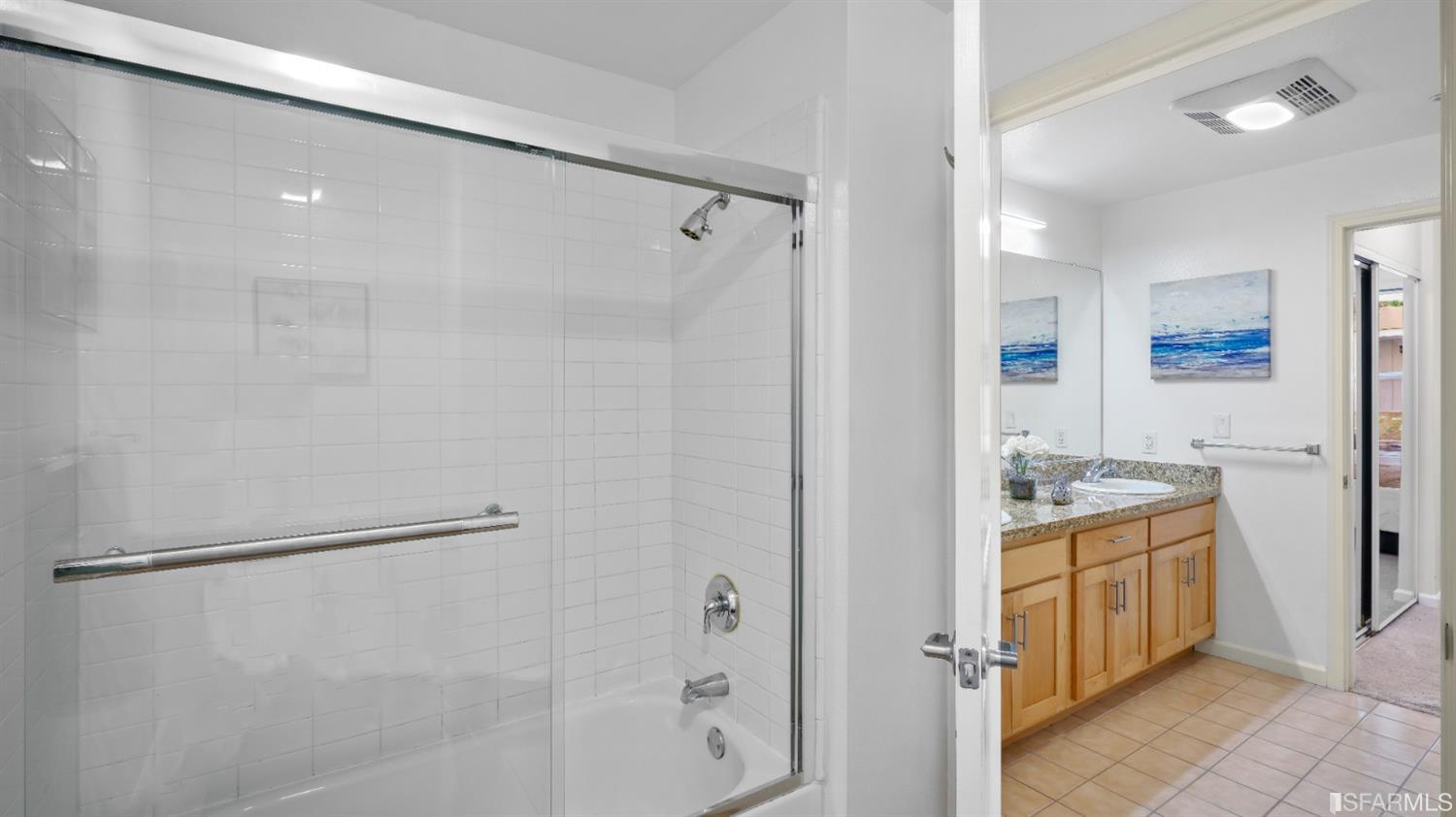 301 Crescent Court, Unit 3117 San Francisco, CA 94134 - Photo 13 of 34 a bathroom with a granite countertop shower mirror and a sink