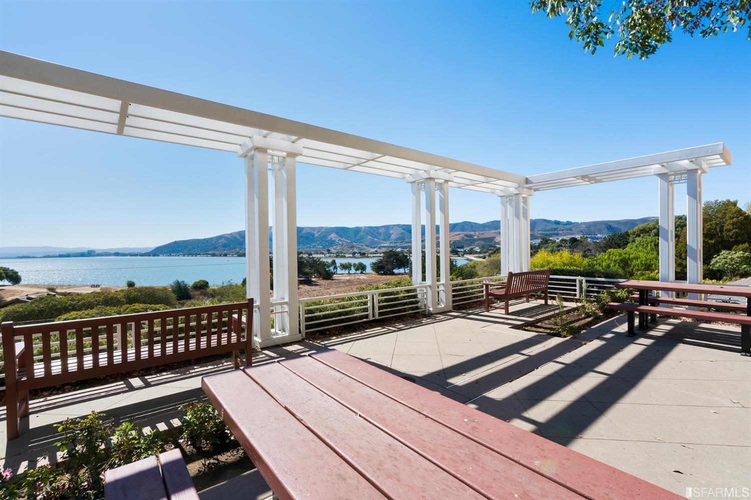 301 Crescent Court, Unit 3117 San Francisco, CA 94134 - Photo 23 of 34 a view of a balcony with couch and wooden floor