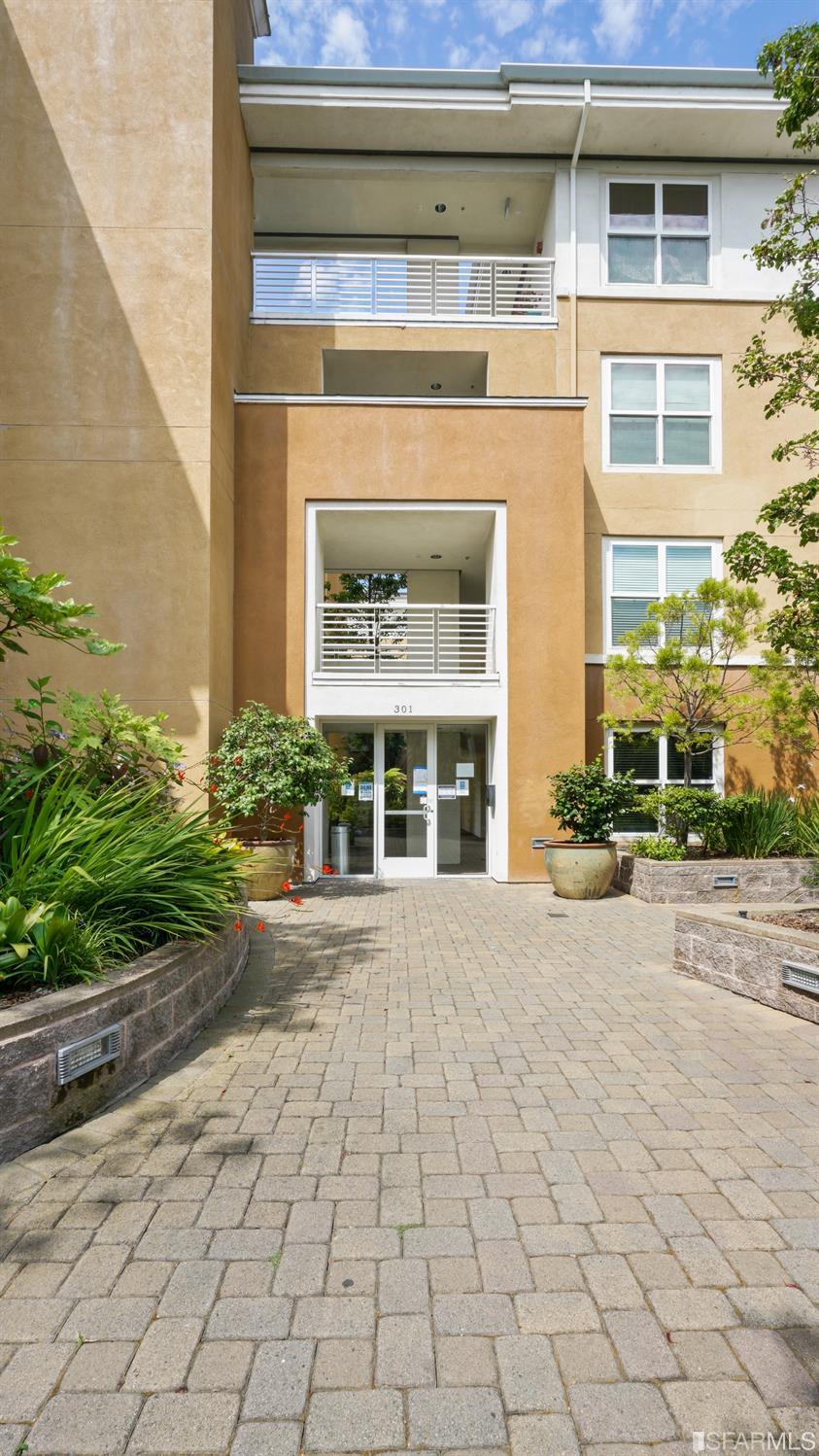 301 Crescent Court, Unit 3117 San Francisco, CA 94134 - Photo 30 of 34 a view of a building with a window and a yard