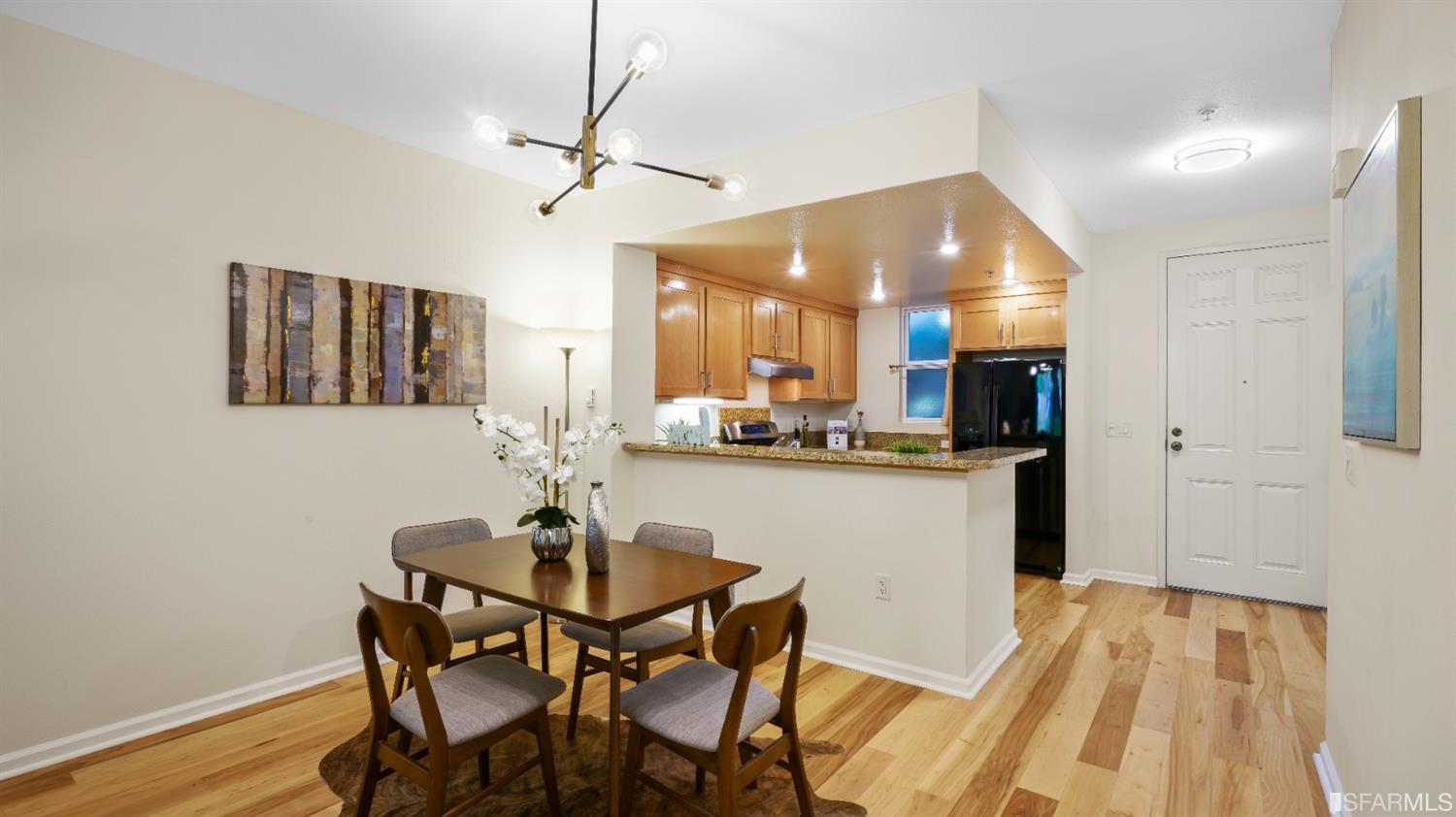301 Crescent Court, Unit 3117 San Francisco, CA 94134 - Photo 4 of 34 a view of a dining room with furniture and wooden floor