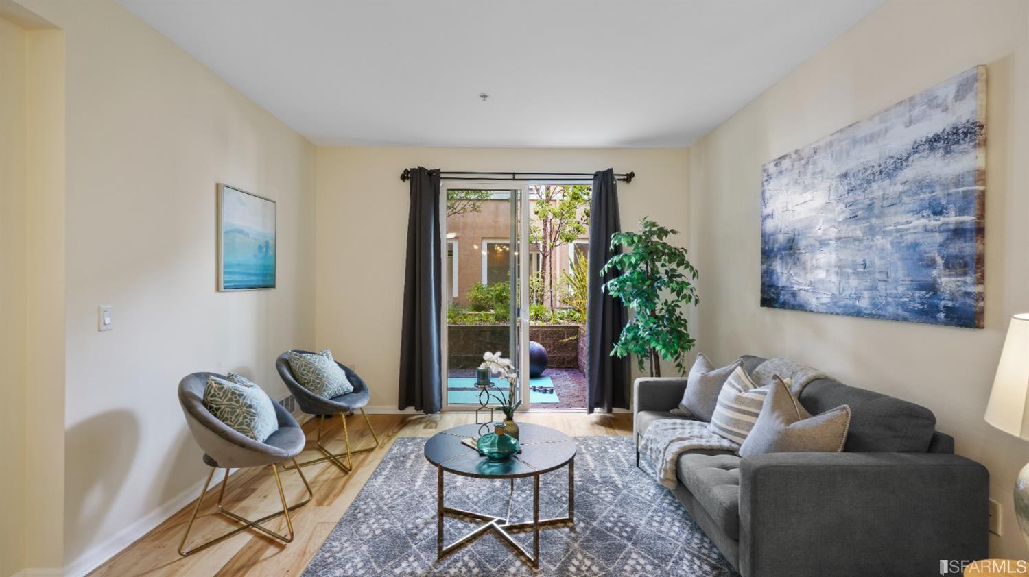 301 Crescent Court, Unit 3117 San Francisco, CA 94134 - Photo 6 of 34 a living room with furniture potted plant and a window