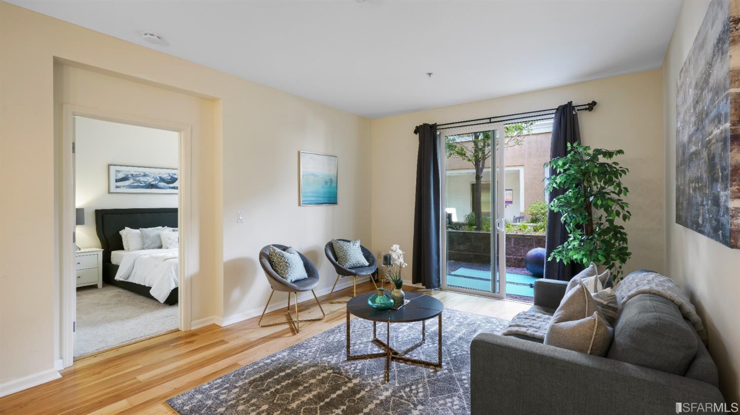 301 Crescent Court, Unit 3117 San Francisco, CA 94134 - Photo 7 of 34 a living room with furniture and a potted plant