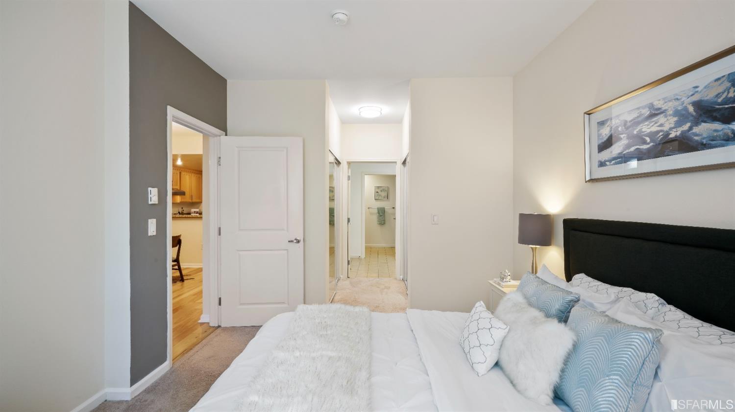 301 Crescent Court, Unit 3117 San Francisco, CA 94134 - Photo 10 of 34 a bedroom with a bed and a painting on the wall