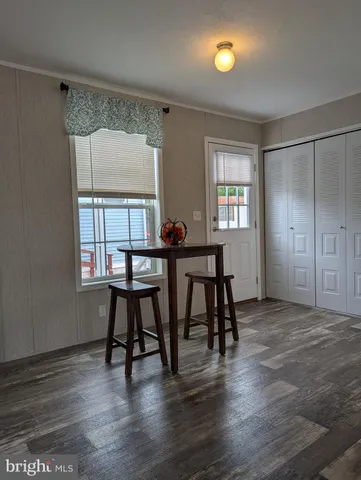 a view of a dining room with furniture and window