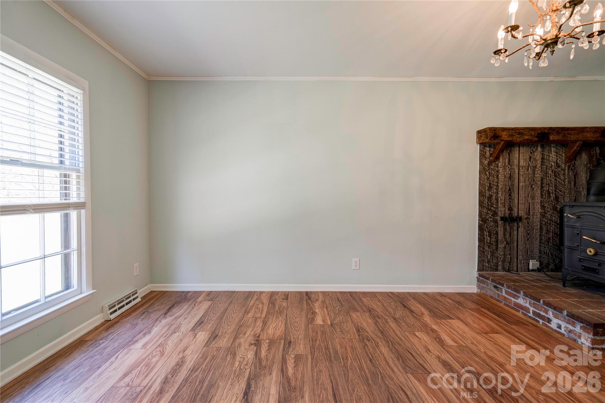 431 North Main Street Shelby, NC 28152 - Photo 12 of 37 an empty room with wooden floor and windows