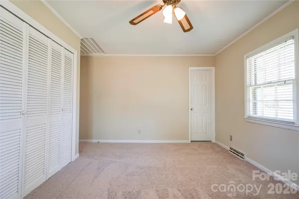 a bathroom with a granite countertop toilet a sink and a mirror