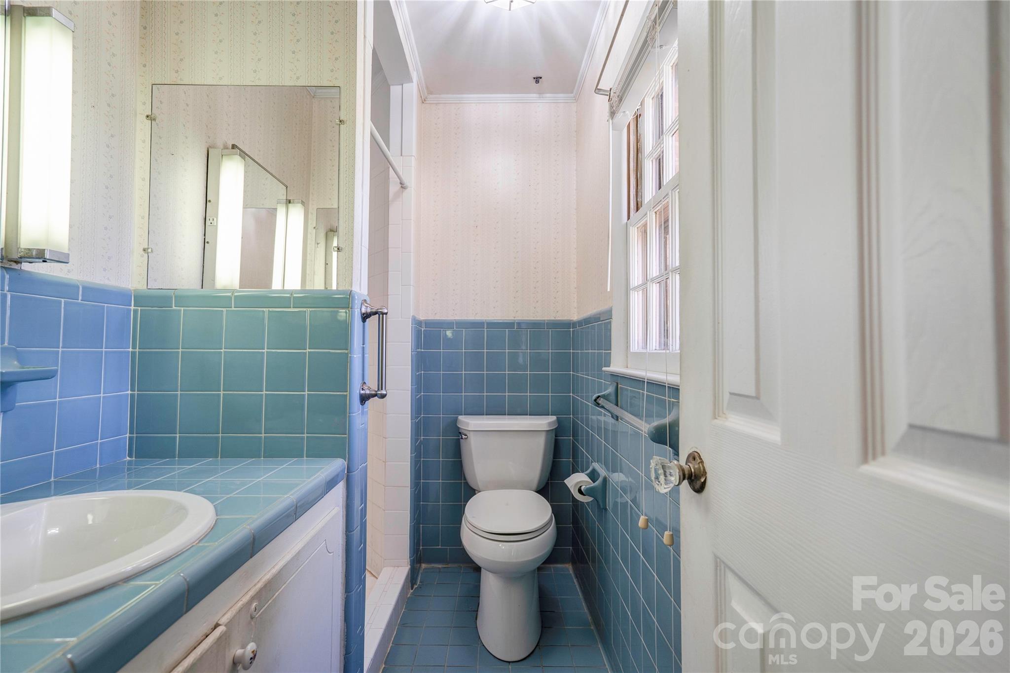 431 North Main Street Shelby, NC 28152 - Photo 16 of 37 a bathroom with a granite countertop toilet a sink and a mirror