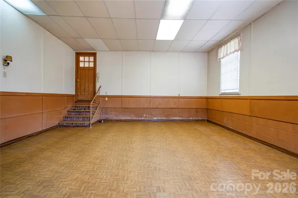 a hallway with white cabinets