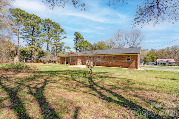 a view of backyard with swimming pool and outdoor seating