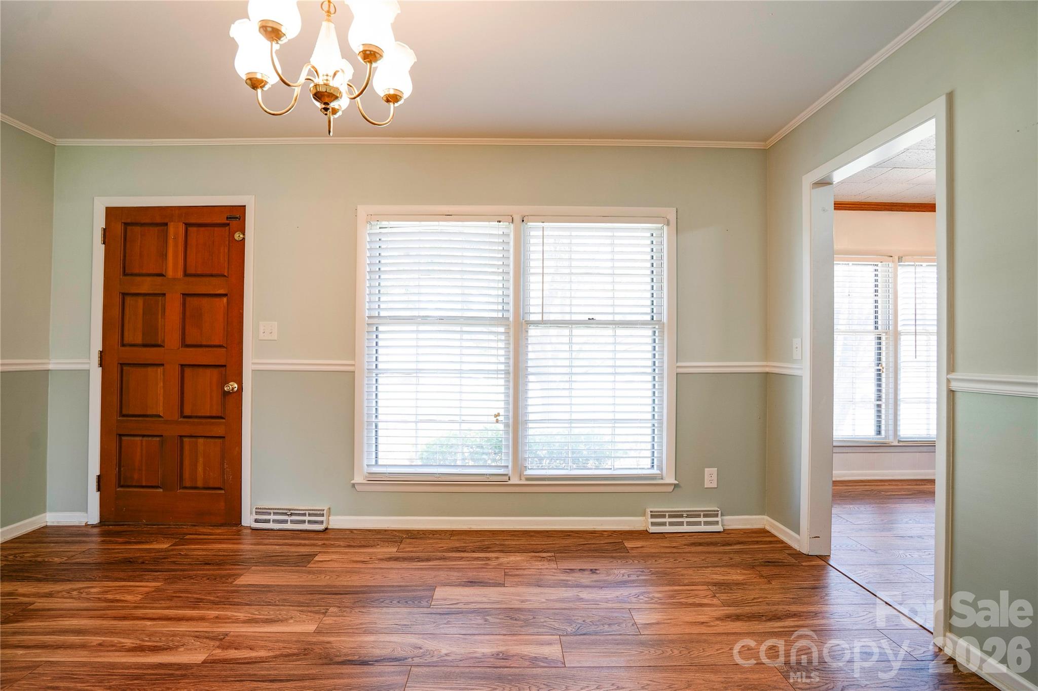431 North Main Street Shelby, NC 28152 - Photo 7 of 37 a view of an empty room with a window and wooden floor