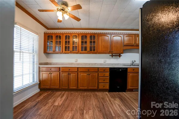 a view of empty room with window and wooden floor