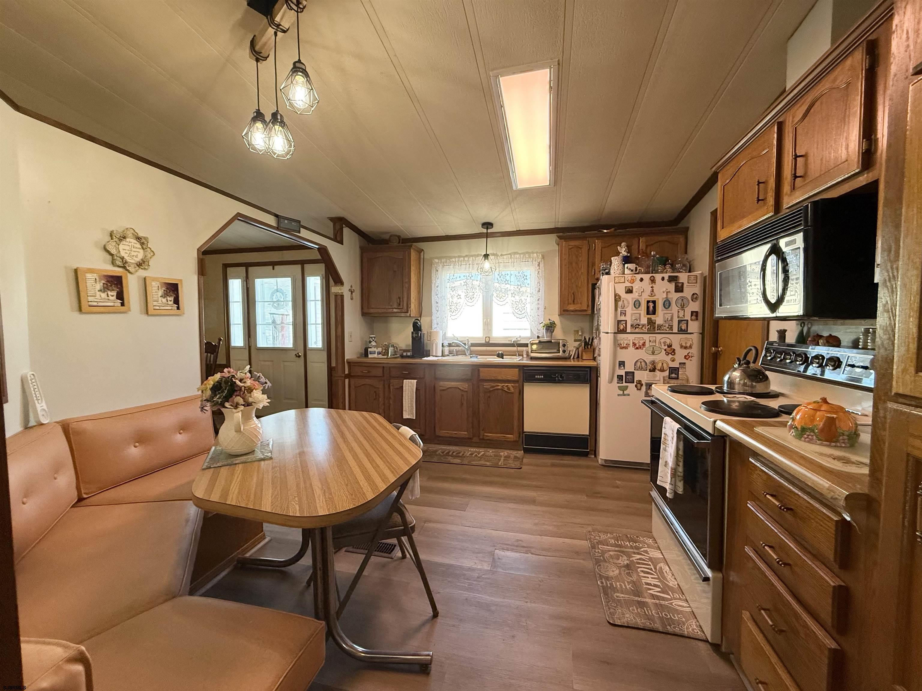 443 Priscilla Lane Buena, NJ 08310 - Photo 15 of 37 a large kitchen with stainless steel appliances kitchen island granite countertop a table chairs sink and cabinets