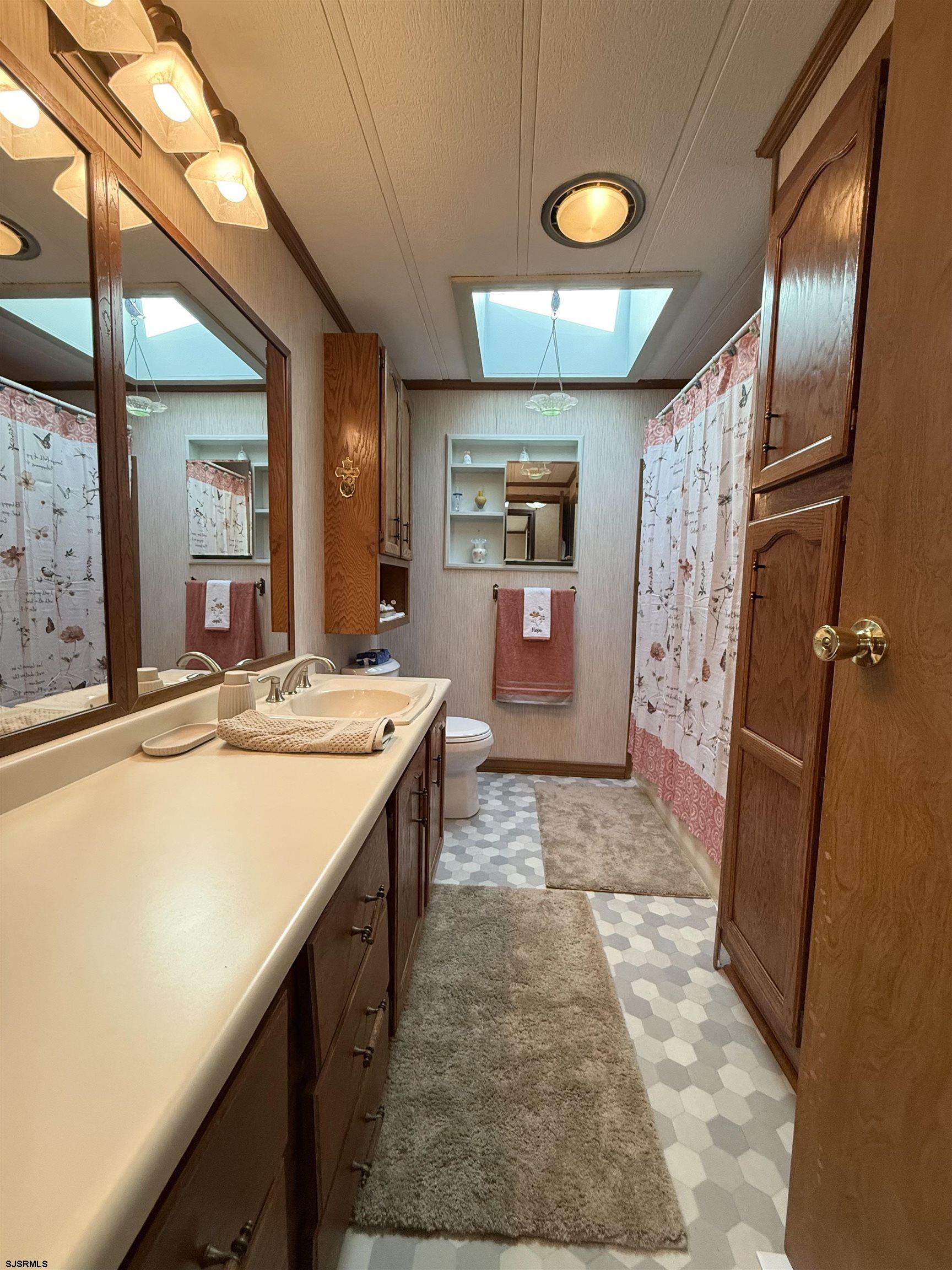 443 Priscilla Lane Buena, NJ 08310 - Photo 21 of 37 a bathroom with a sink a vanity and a large mirror
