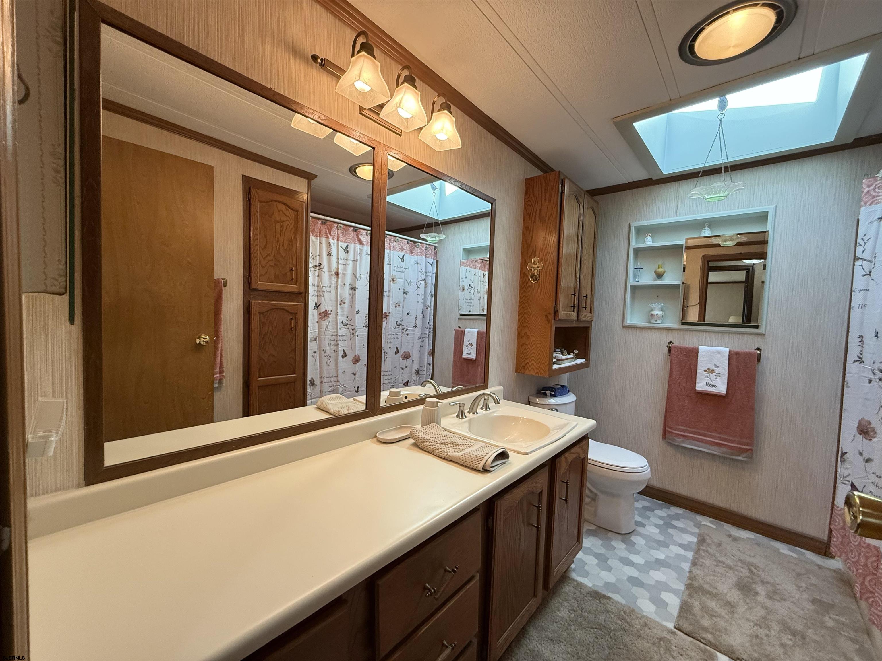 443 Priscilla Lane Buena, NJ 08310 - Photo 22 of 37 a bathroom with a sink a vanity and a large mirror