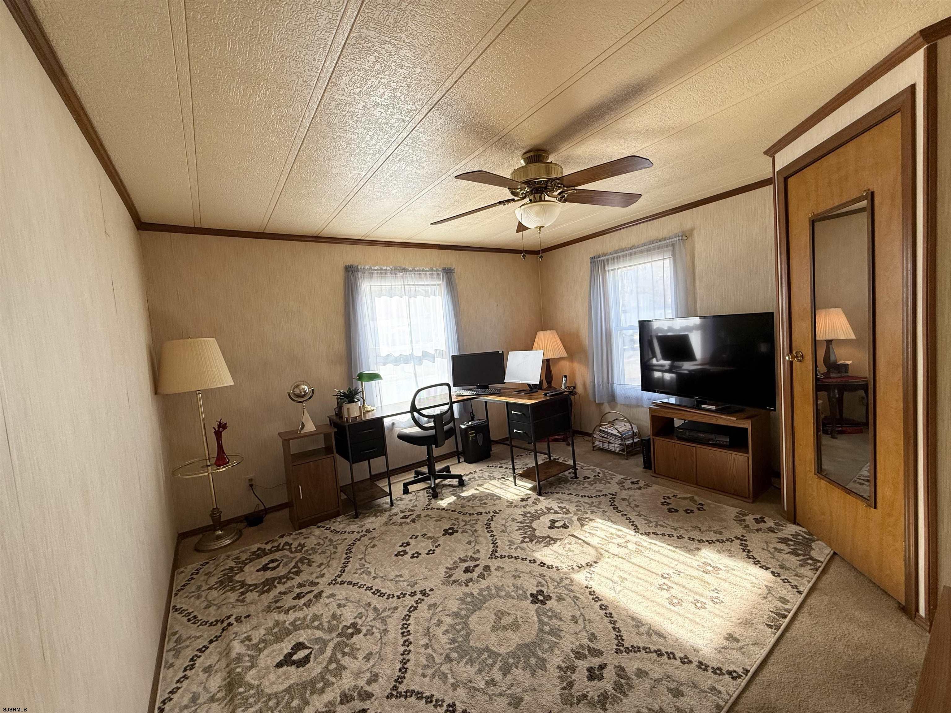 443 Priscilla Lane Buena, NJ 08310 - Photo 24 of 37 a living room with furniture a flat screen tv and a refrigerator