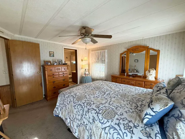 a bedroom with a bed closet and a mirror