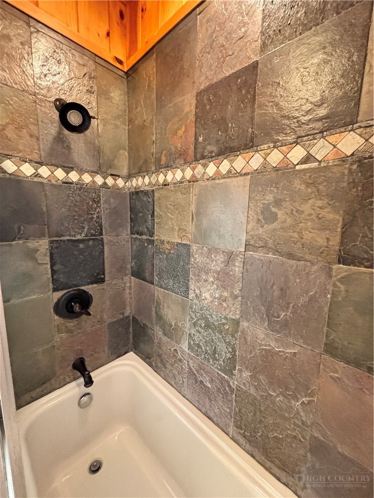 150 Turkey Ridge Crumpler, NC 28617 - Photo 29 of 40 a bathroom with a shower and a sink