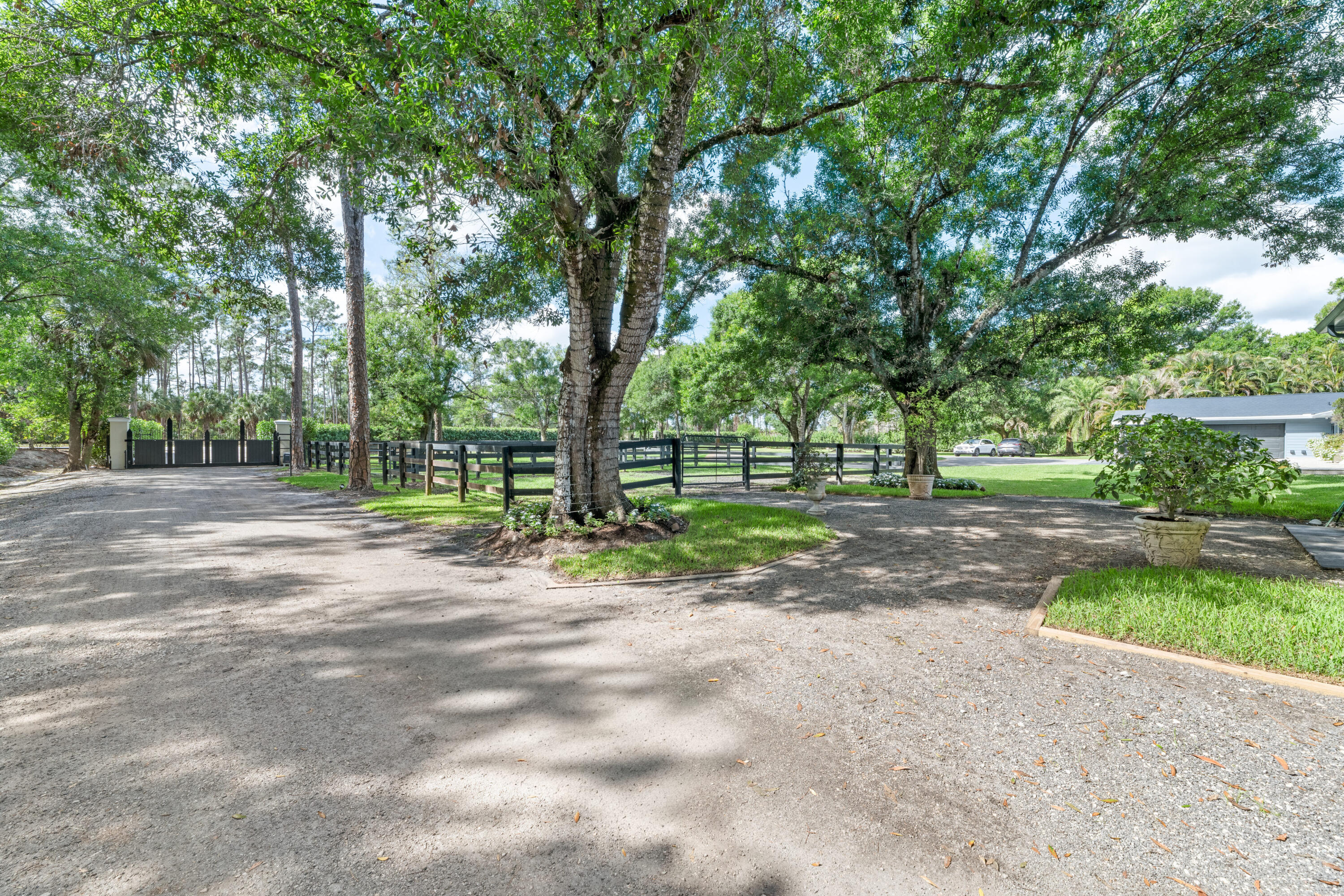 15161 Collecting Canal Road Loxahatchee Groves, FL 33470 - Photo 39 of 69 Barn One Paddocks with Oak trees