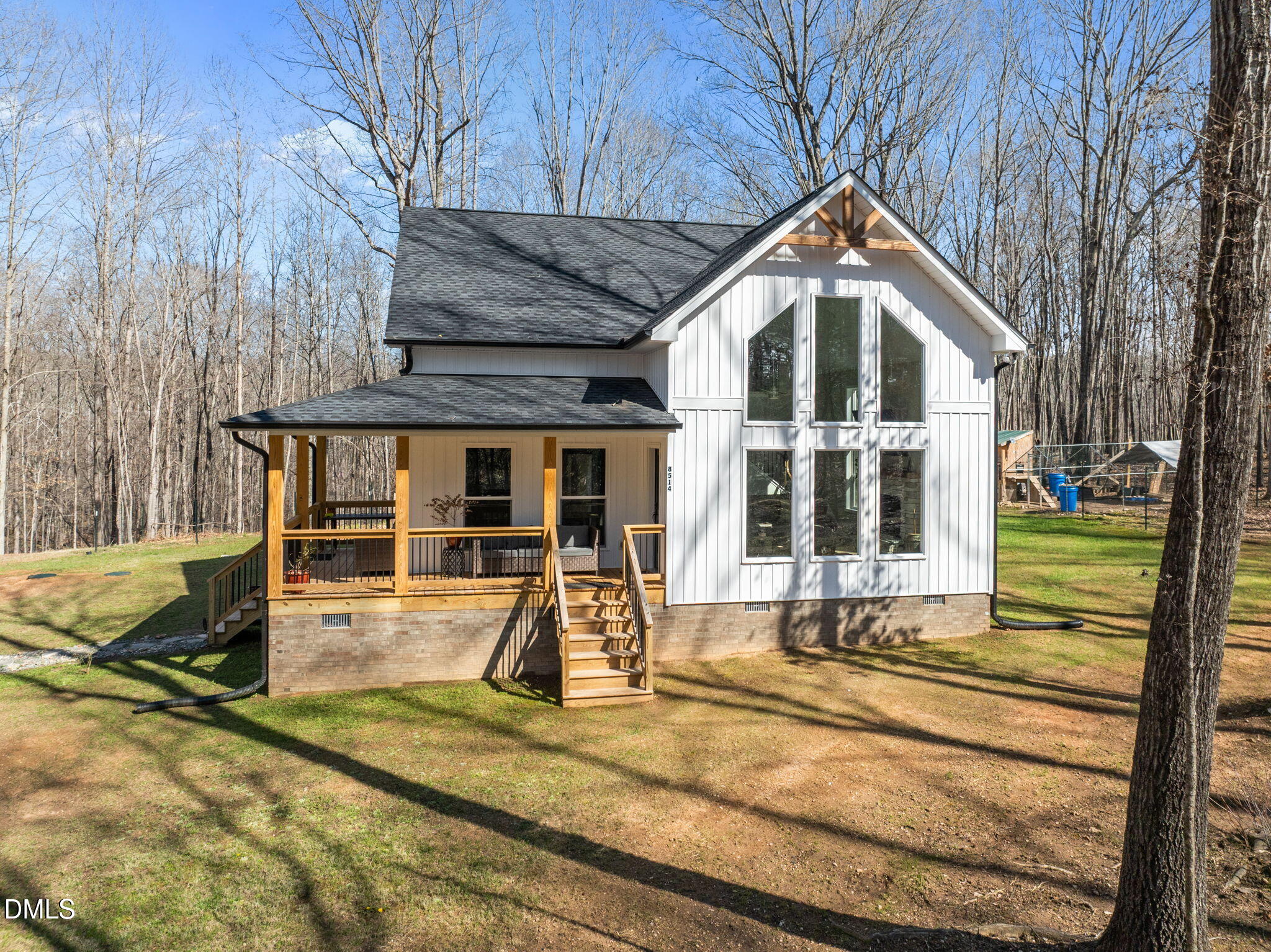 8514 Charlie Stovall Road Roxboro, NC 27574 - Photo 5 of 48 a view of a house with large windows and yard