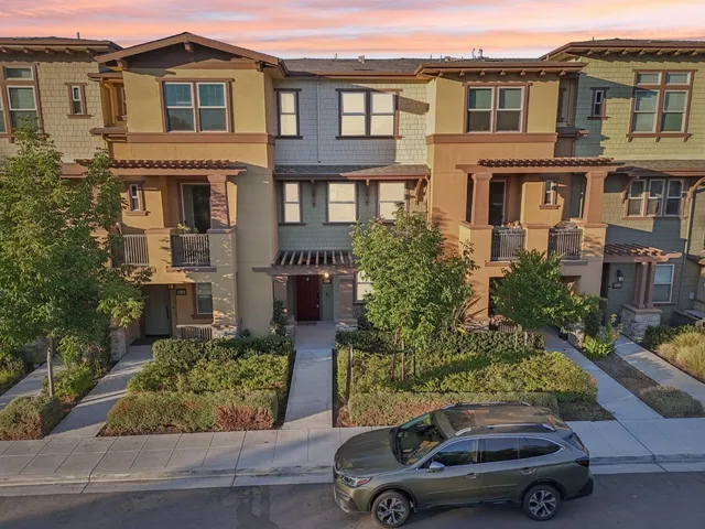 a car parked in front of a brick house
