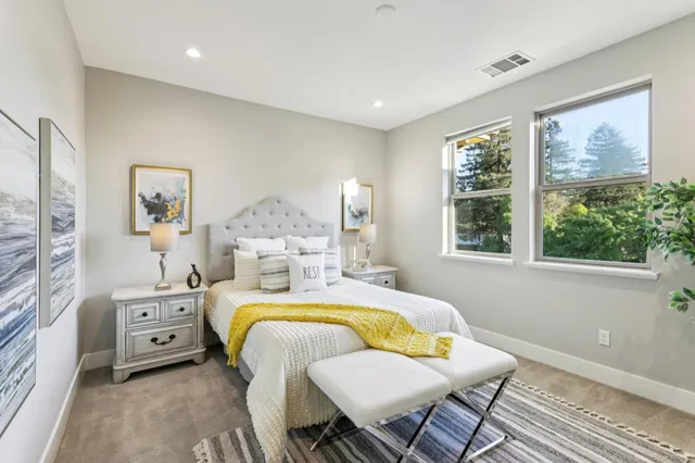 a bed room with a bed and a chair