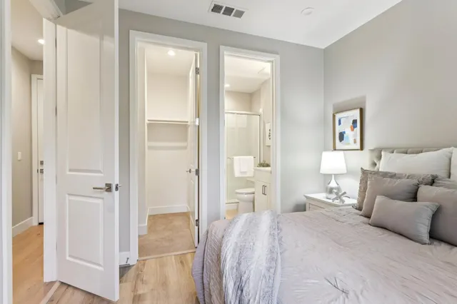 a bedroom with a bed and a mirror