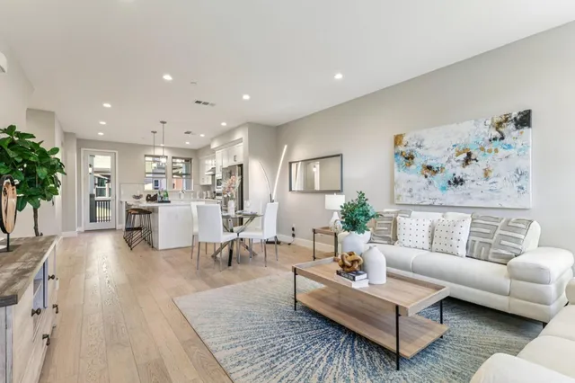 a living room with furniture and view of kitchen