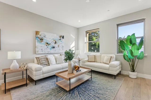 a living room with furniture potted plant and a window