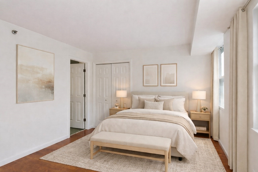 170 Tremont Street, Unit 504 Boston, MA 02111 - Photo 13 of 27 a bedroom with a bed and a night stand