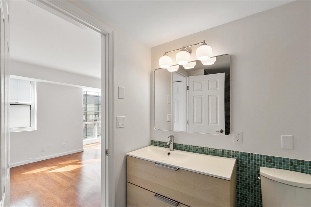 170 Tremont Street, Unit 504 Boston, MA 02111 - Photo 23 of 27 a bathroom with a sink and a mirror