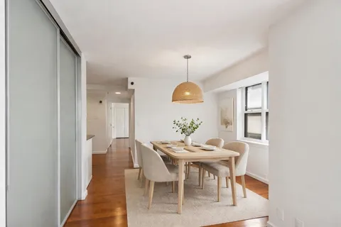 a view of a dining room with furniture and window