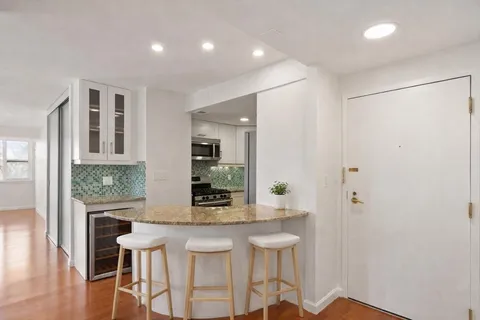 a kitchen with dining table and chairs