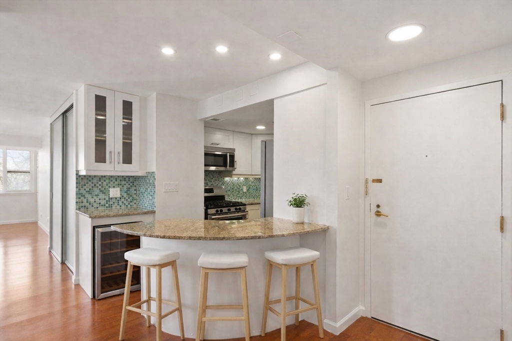 170 Tremont Street, Unit 504 Boston, MA 02111 - Photo 9 of 27 a kitchen with dining table and chairs