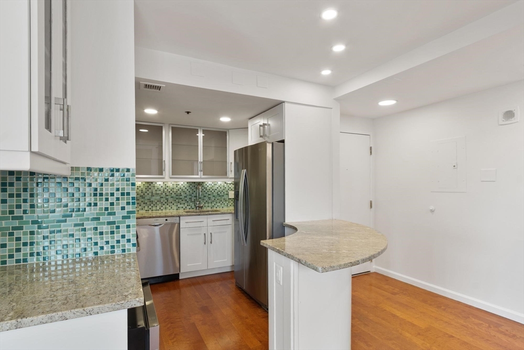 170 Tremont Street, Unit 504 Boston, MA 02111 - Photo 10 of 27 a kitchen with a sink microwave and refrigerator
