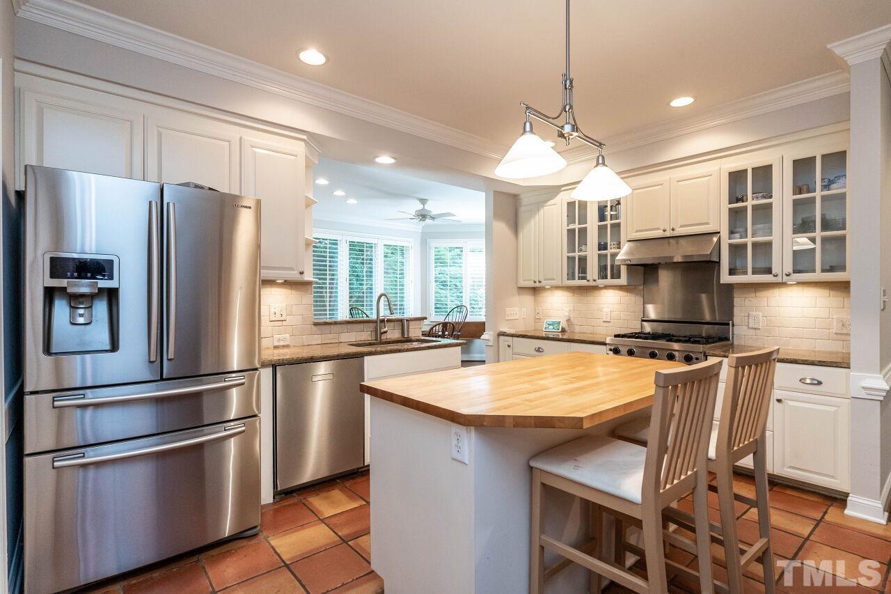 3129 Eton Road Raleigh, NC 27608 - Photo 14 of 44 a kitchen with stainless steel appliances granite countertop a sink stove and refrigerator